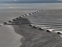 Seeders are lining up to sow seeds at a planting base in Shenyang, Liaoning Province, China, on April 22, 2024. (