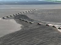 Seeders are lining up to sow seeds at a planting base in Shenyang, Liaoning Province, China, on April 22, 2024. (