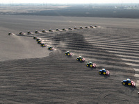 Seeders are lining up to sow seeds at a planting base in Shenyang, Liaoning Province, China, on April 22, 2024. (