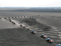 Seeders are lining up to sow seeds at a planting base in Shenyang, Liaoning Province, China, on April 22, 2024. (