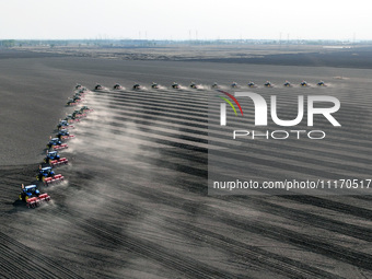 Seeders are lining up to sow seeds at a planting base in Shenyang, Liaoning Province, China, on April 22, 2024. (