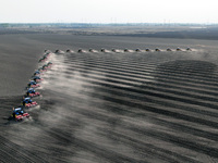 Seeders are lining up to sow seeds at a planting base in Shenyang, Liaoning Province, China, on April 22, 2024. (