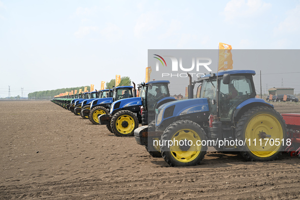 Seeders are lining up to sow seeds at a planting base in Shenyang, Liaoning Province, China, on April 22, 2024. 