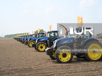 Seeders are lining up to sow seeds at a planting base in Shenyang, Liaoning Province, China, on April 22, 2024. (