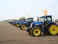 Seeders are lining up to sow seeds at a planting base in Shenyang, Liaoning Province, China, on April 22, 2024. (