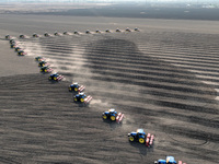 Seeders are lining up to sow seeds at a planting base in Shenyang, Liaoning Province, China, on April 22, 2024. (