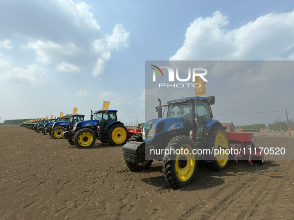 Seeders are lining up to sow seeds at a planting base in Shenyang, Liaoning Province, China, on April 22, 2024. 