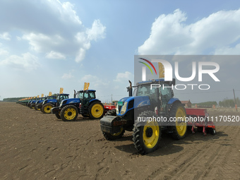 Seeders are lining up to sow seeds at a planting base in Shenyang, Liaoning Province, China, on April 22, 2024. (