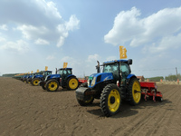 Seeders are lining up to sow seeds at a planting base in Shenyang, Liaoning Province, China, on April 22, 2024. (