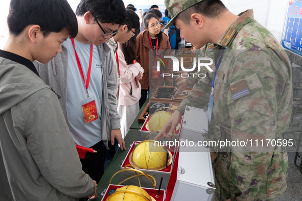 People are viewing naval equipment during the Open Ship Day in Shanghai, China, on April 23, 2024. 