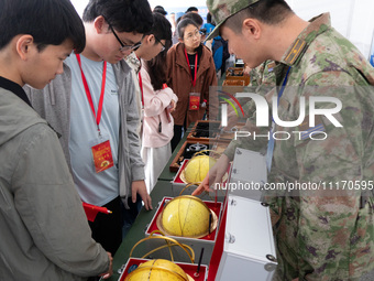 People are viewing naval equipment during the Open Ship Day in Shanghai, China, on April 23, 2024. (