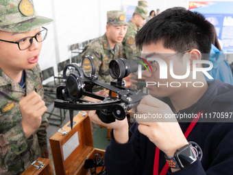 A visitor is learning to use naval equipment during the Open Ship Day in Shanghai, China, on April 23, 2024. (