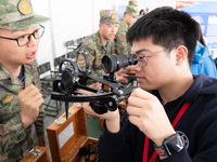 A visitor is learning to use naval equipment during the Open Ship Day in Shanghai, China, on April 23, 2024. (