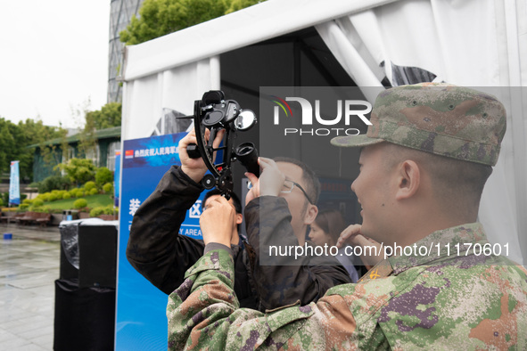 A visitor is learning to use naval equipment during the Open Ship Day in Shanghai, China, on April 23, 2024. 