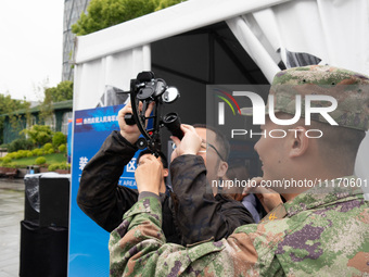 A visitor is learning to use naval equipment during the Open Ship Day in Shanghai, China, on April 23, 2024. (