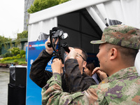 A visitor is learning to use naval equipment during the Open Ship Day in Shanghai, China, on April 23, 2024. (