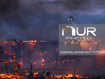 EDMONTON, CANADA - APRIL 22:
Firefighters relentlessly combat flames that tore through Edmonton's historic Hangar 11 on Monday evening, on A...