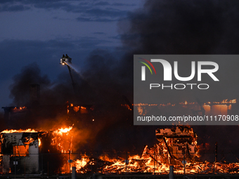 EDMONTON, CANADA - APRIL 22:
Firefighters relentlessly combat flames that tore through Edmonton's historic Hangar 11 on Monday evening, on A...