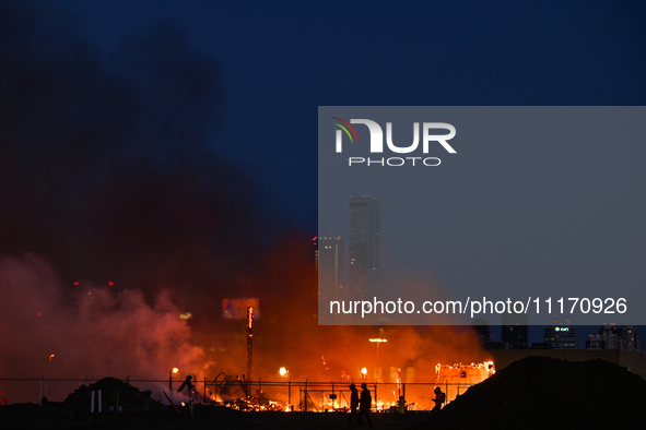 EDMONTON, CANADA - APRIL 22:
Locals approach the fire site, risking their health as several units of firefighters combat the flames that tor...