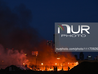 EDMONTON, CANADA - APRIL 22:
Locals approach the fire site, risking their health as several units of firefighters combat the flames that tor...