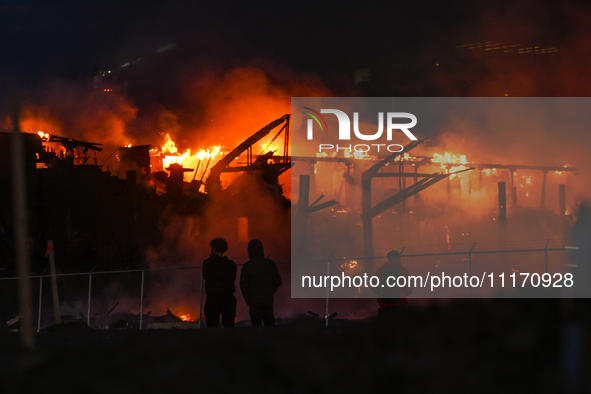 EDMONTON, CANADA - APRIL 22:
Locals approach the fire site, risking their health as several units of firefighters combat the flames that tor...