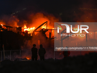 EDMONTON, CANADA - APRIL 22:
Locals approach the fire site, risking their health as several units of firefighters combat the flames that tor...