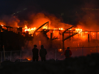 EDMONTON, CANADA - APRIL 22:
Locals approach the fire site, risking their health as several units of firefighters combat the flames that tor...