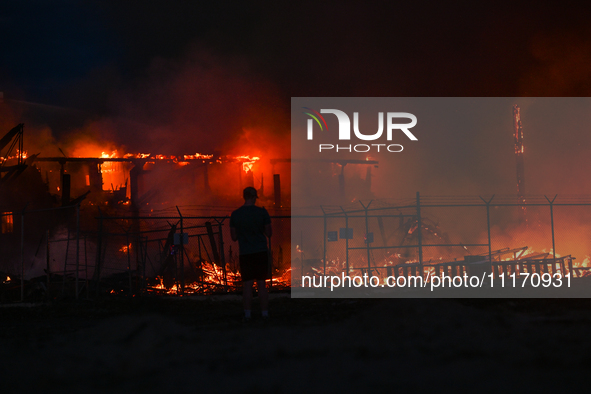 EDMONTON, CANADA - APRIL 22:
Local man approaches the fire site, risking his health as several units of firefighters combat the flames that...