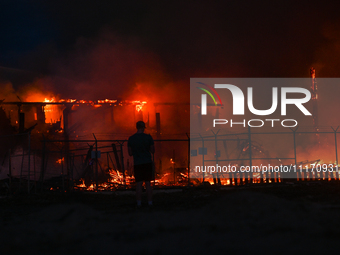 EDMONTON, CANADA - APRIL 22:
Local man approaches the fire site, risking his health as several units of firefighters combat the flames that...