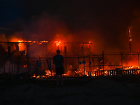 EDMONTON, CANADA - APRIL 22:
Local man approaches the fire site, risking his health as several units of firefighters combat the flames that...