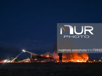 EDMONTON, CANADA - APRIL 22:
Local man approaches the fire site, risking his health as several units of firefighters combat the flames that...