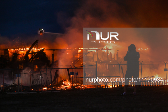 EDMONTON, CANADA - APRIL 22:
Local man approaches the fire site, risking his health as several units of firefighters combat the flames that...