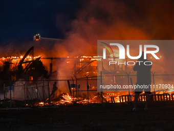 EDMONTON, CANADA - APRIL 22:
Local man approaches the fire site, risking his health as several units of firefighters combat the flames that...