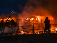 EDMONTON, CANADA - APRIL 22:
Local man approaches the fire site, risking his health as several units of firefighters combat the flames that...