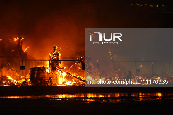 EDMONTON, CANADA - APRIL 22:
A local approaches the fire site, risking his health as several units of firefighters combat the flames that to...