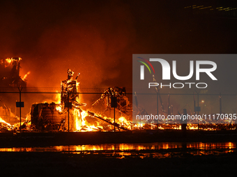 EDMONTON, CANADA - APRIL 22:
A local approaches the fire site, risking his health as several units of firefighters combat the flames that to...