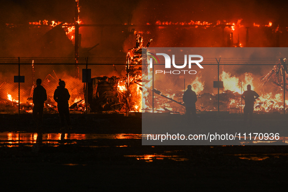 EDMONTON, CANADA - APRIL 22:
Local approach the fire site, risking his health as several units of firefighters combat the flames that tore t...