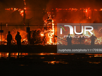 EDMONTON, CANADA - APRIL 22:
Local approach the fire site, risking his health as several units of firefighters combat the flames that tore t...