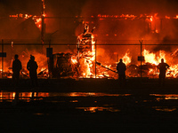 EDMONTON, CANADA - APRIL 22:
Local approach the fire site, risking his health as several units of firefighters combat the flames that tore t...