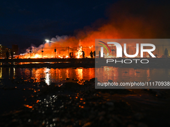 EDMONTON, CANADA - APRIL 22:
Local approach the fire site, risking his health as several units of firefighters combat the flames that tore t...