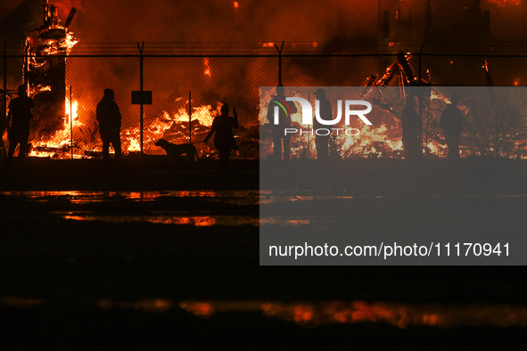 EDMONTON, CANADA - APRIL 22:
Local approach the fire site, risking his health as several units of firefighters combat the flames that tore t...