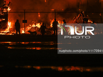 EDMONTON, CANADA - APRIL 22:
Local approach the fire site, risking his health as several units of firefighters combat the flames that tore t...