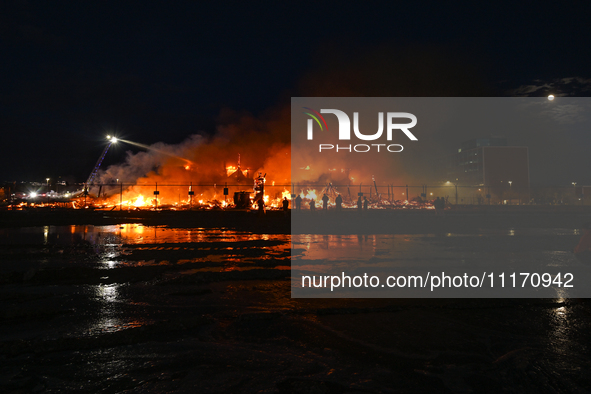 EDMONTON, CANADA - APRIL 22:
Local approach the fire site, risking his health as several units of firefighters combat the flames that tore t...