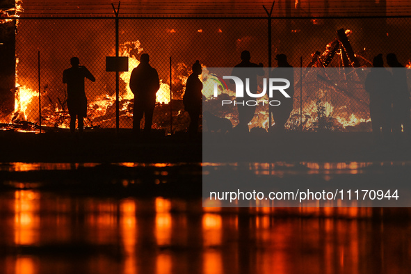 EDMONTON, CANADA - APRIL 22:
Local approach the fire site, risking his health as several units of firefighters combat the flames that tore t...