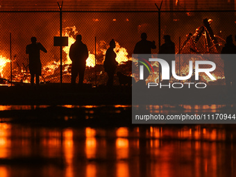 EDMONTON, CANADA - APRIL 22:
Local approach the fire site, risking his health as several units of firefighters combat the flames that tore t...