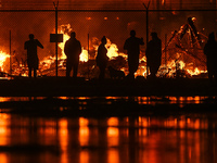 EDMONTON, CANADA - APRIL 22:
Local approach the fire site, risking his health as several units of firefighters combat the flames that tore t...