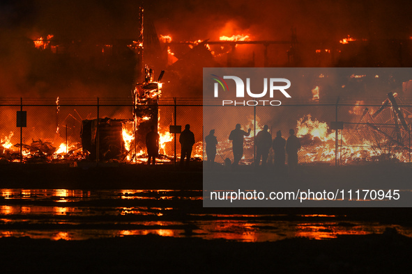 EDMONTON, CANADA - APRIL 22:
Local approach the fire site, risking his health as several units of firefighters combat the flames that tore t...