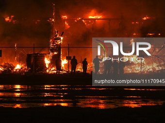 EDMONTON, CANADA - APRIL 22:
Local approach the fire site, risking his health as several units of firefighters combat the flames that tore t...