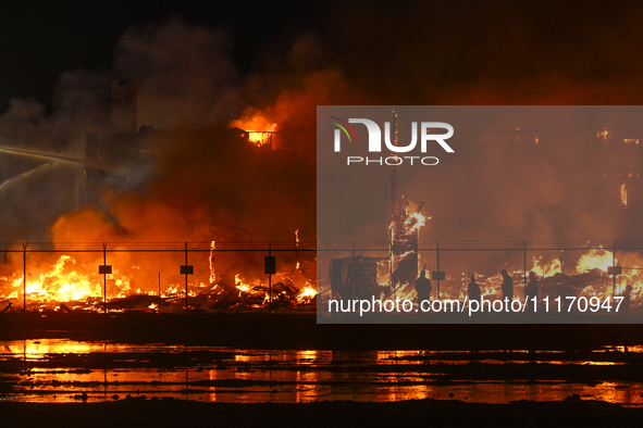 EDMONTON, CANADA - APRIL 22:
Local approach the fire site, risking his health as several units of firefighters combat the flames that tore t...