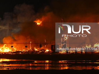 EDMONTON, CANADA - APRIL 22:
Local approach the fire site, risking his health as several units of firefighters combat the flames that tore t...